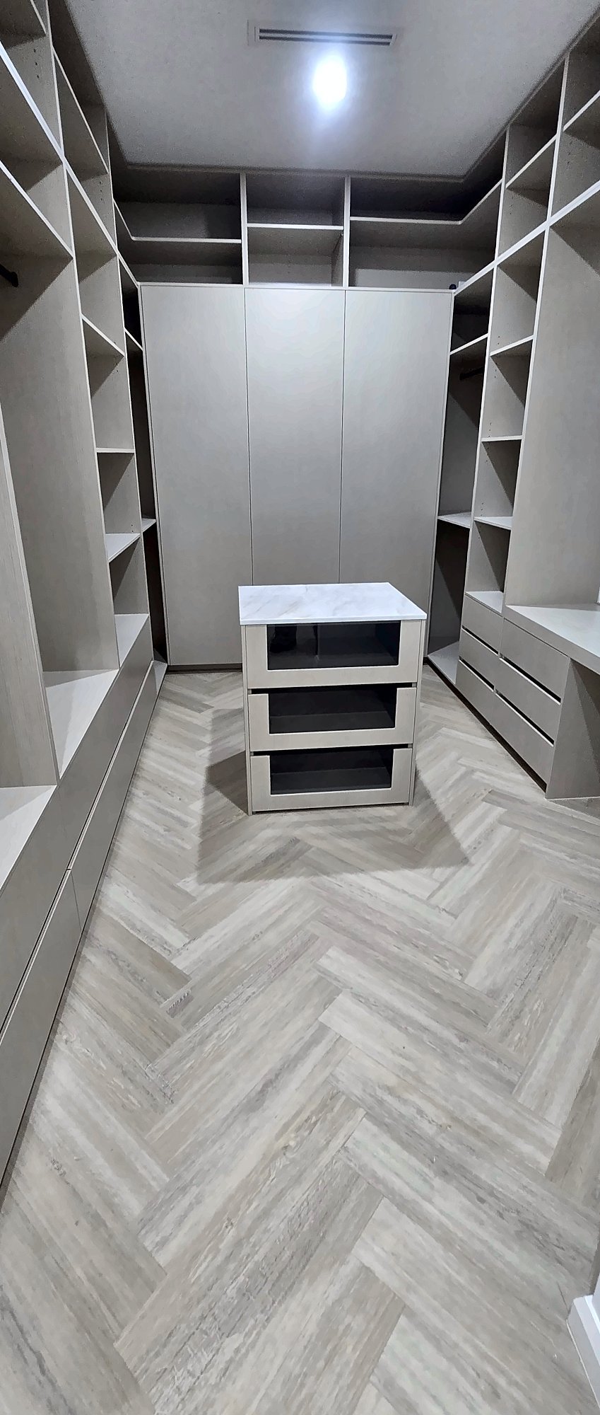 Large walk-in robe with a central drawer island and full-height shelving, by Maya Cabinets in Melbourne